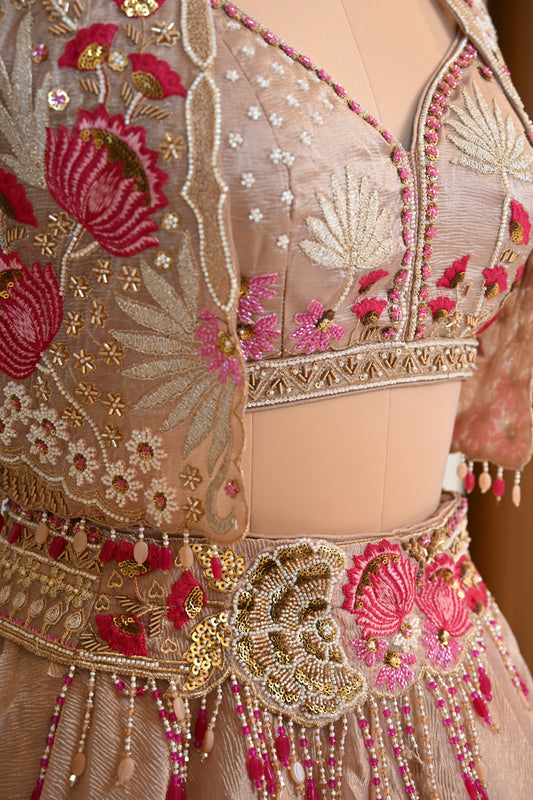 Elegant Powder Peach Tissue Lehenga Choli with Embellished Cape