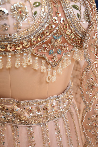 Elegant Powder Peach Lehenga Set crafted In Delicate Net