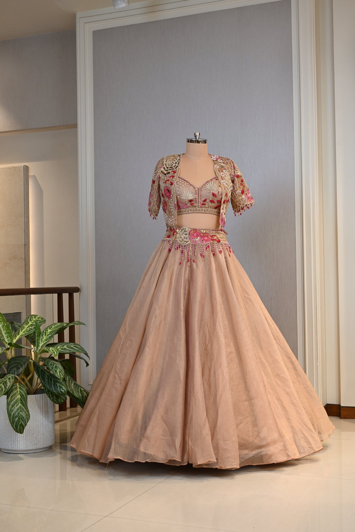 Elegant Powder Peach Tissue Lehenga Choli with Embellished Cape