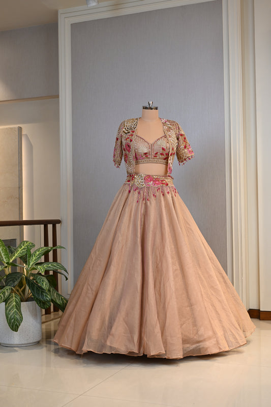 Elegant Powder Peach Tissue Lehenga Choli with Embellished Cape