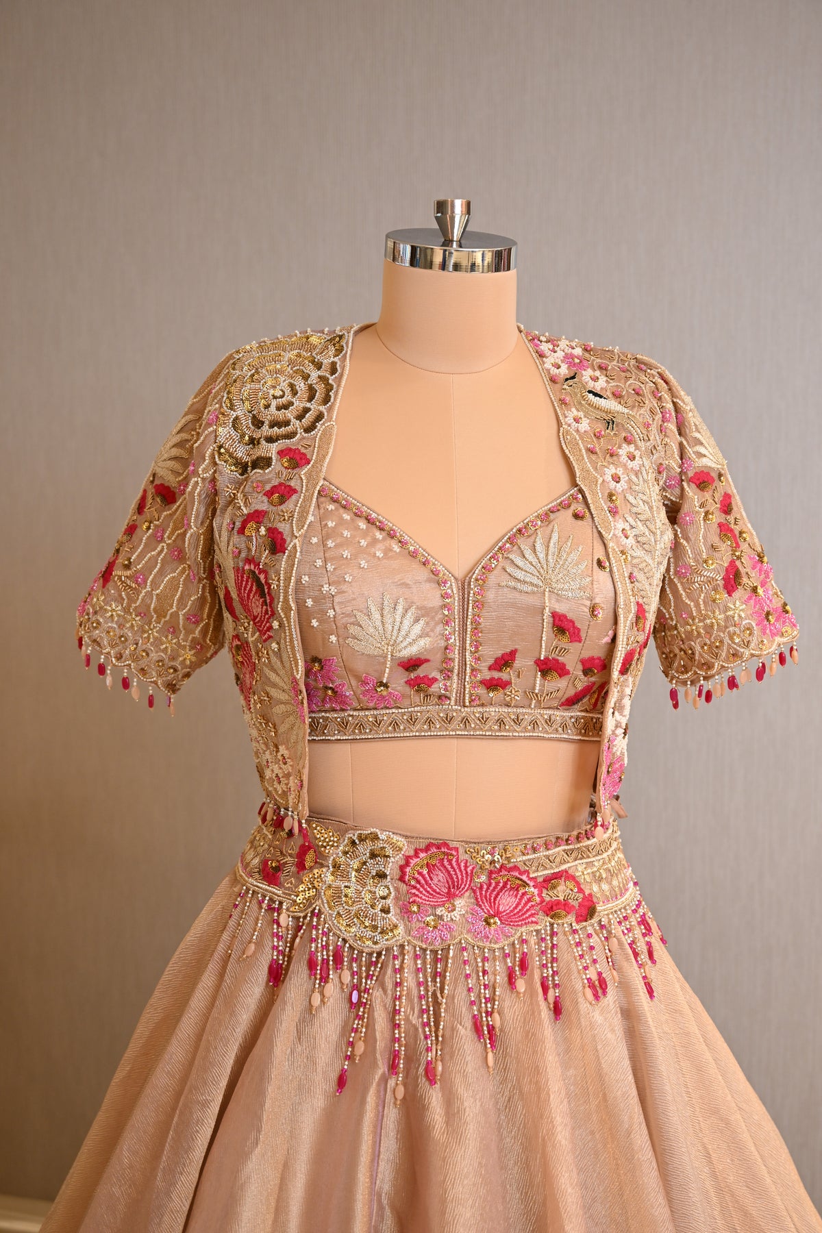 Elegant Powder Peach Tissue Lehenga Choli with Embellished Cape